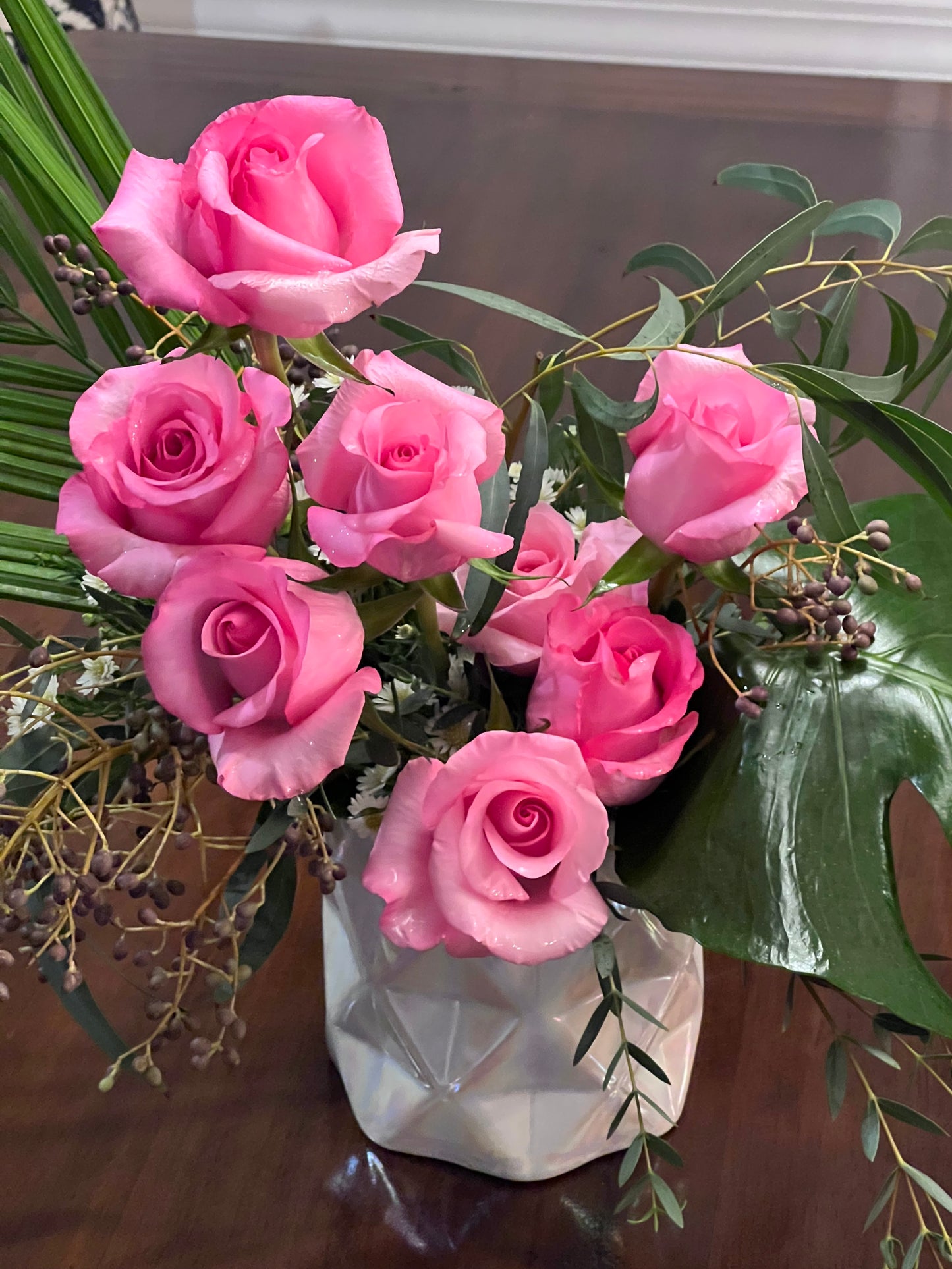 Pink roses with tropicals make the perfect arrangement for office or home.