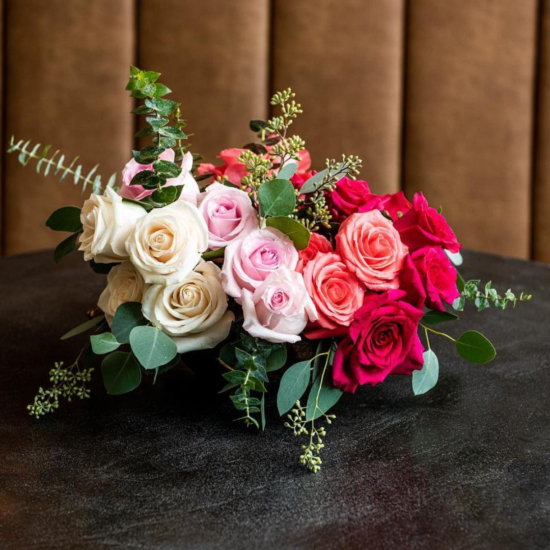 Multi-color centerpiece with rich color roses.  Pink roses, white roses, hot pink roses with greens.  Perfect arrangement for hotels.  Corporate florals. Business flowers. Hotel florist. Charleston hotel florist.  Charleston luxury florist.