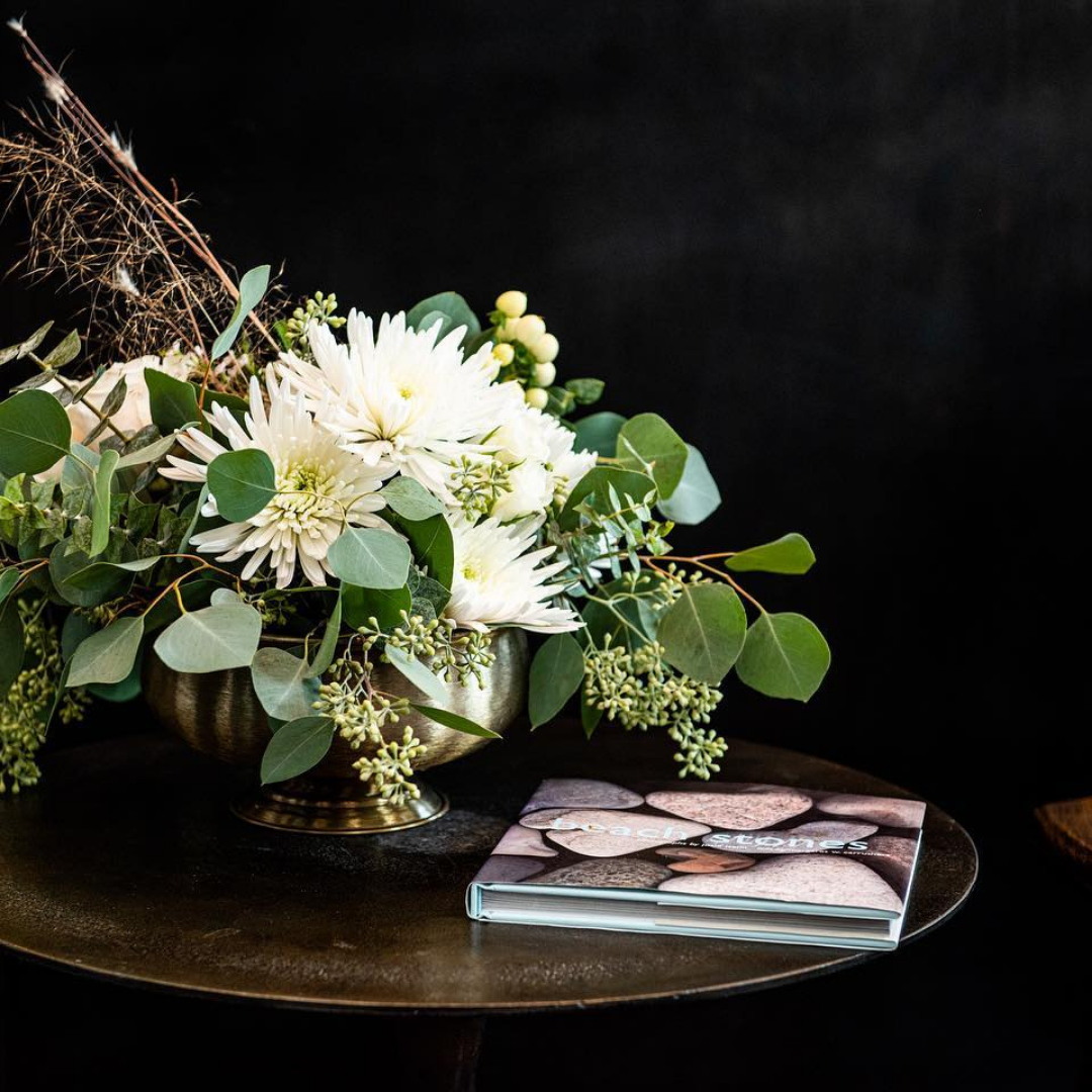 White centerpiece.  Centerpiece for business, hospitality and hotels.  Lobby flowers. Coffee table flowers.  Classic centerpiece.  Low profile white centerpiece. Beautiful  flower arrangement for Easter brunch or dinner.